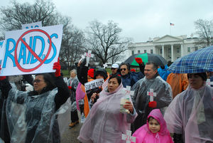 People rally outside of the White House in opposition to immigration raids.