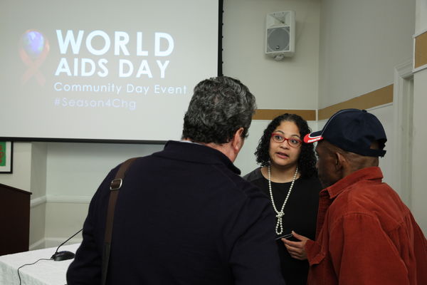 People speak at a conference for World Aids Day