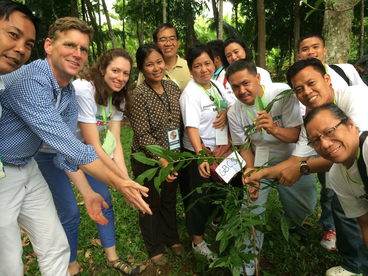 Staff and partners plant a tree in the Philippines