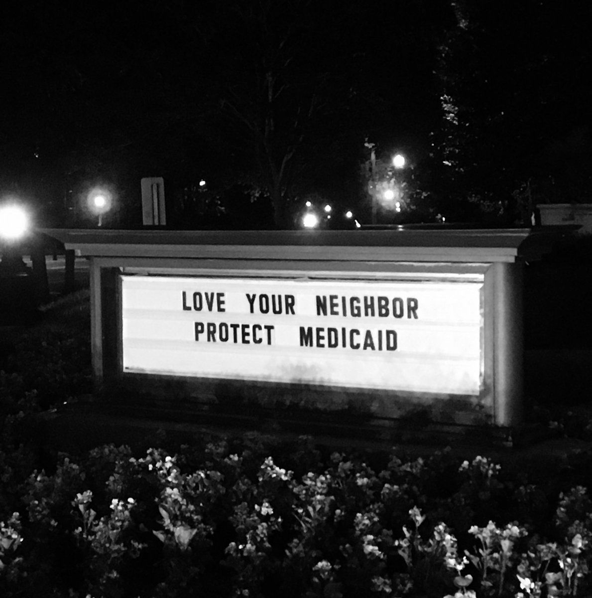Sign outside the United Methodist Building reads, "Love your neighbor, Protect Medicaid."