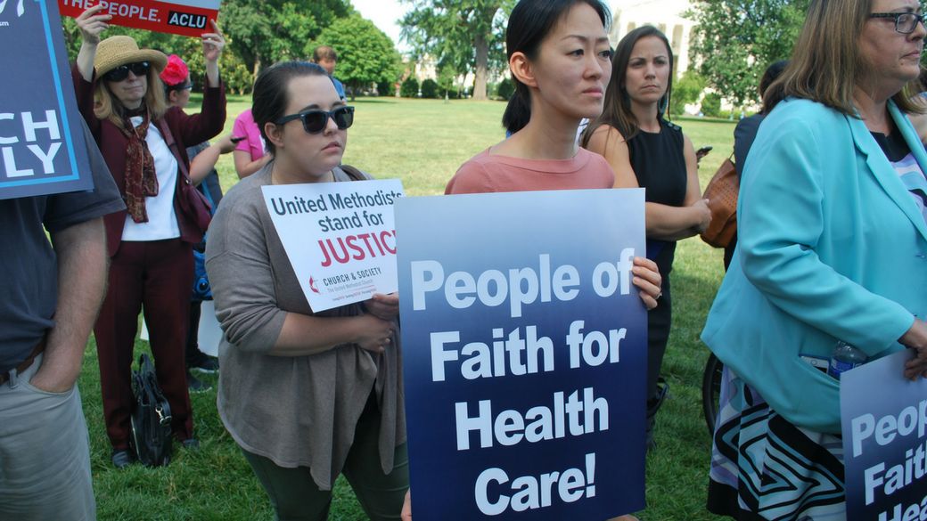 GBCS staff hold signs at health care vigil on U.S. Capitol grounds