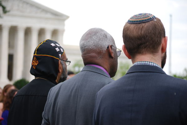 Three men of different faiths standing in front of the U.S. Supreme Court.