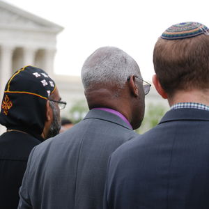 Three men of different faiths standing in front of the U.S. Supreme Court.