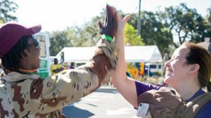 Two people exchange high five.