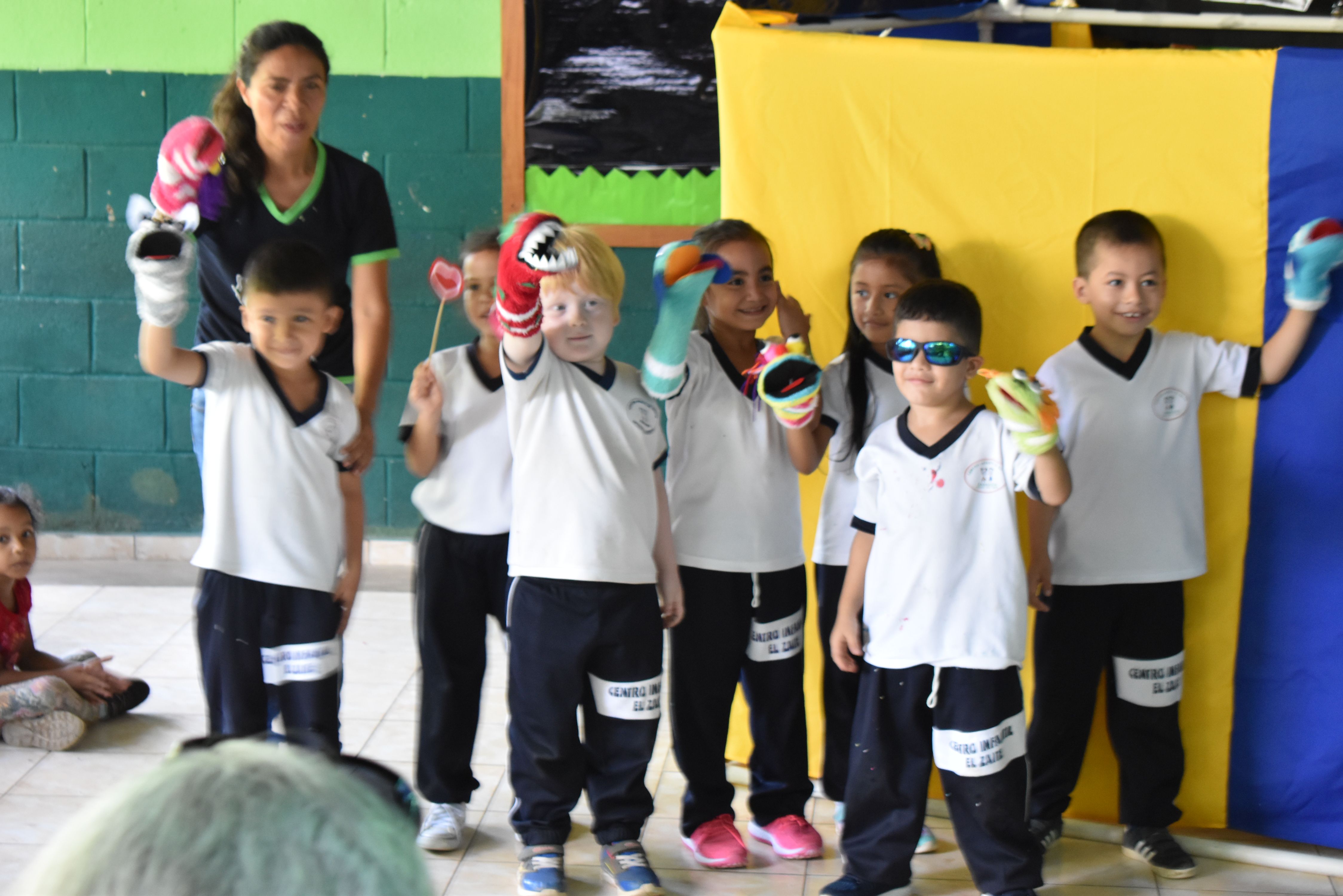 Kids doing a puppet show at a school in El Salvador