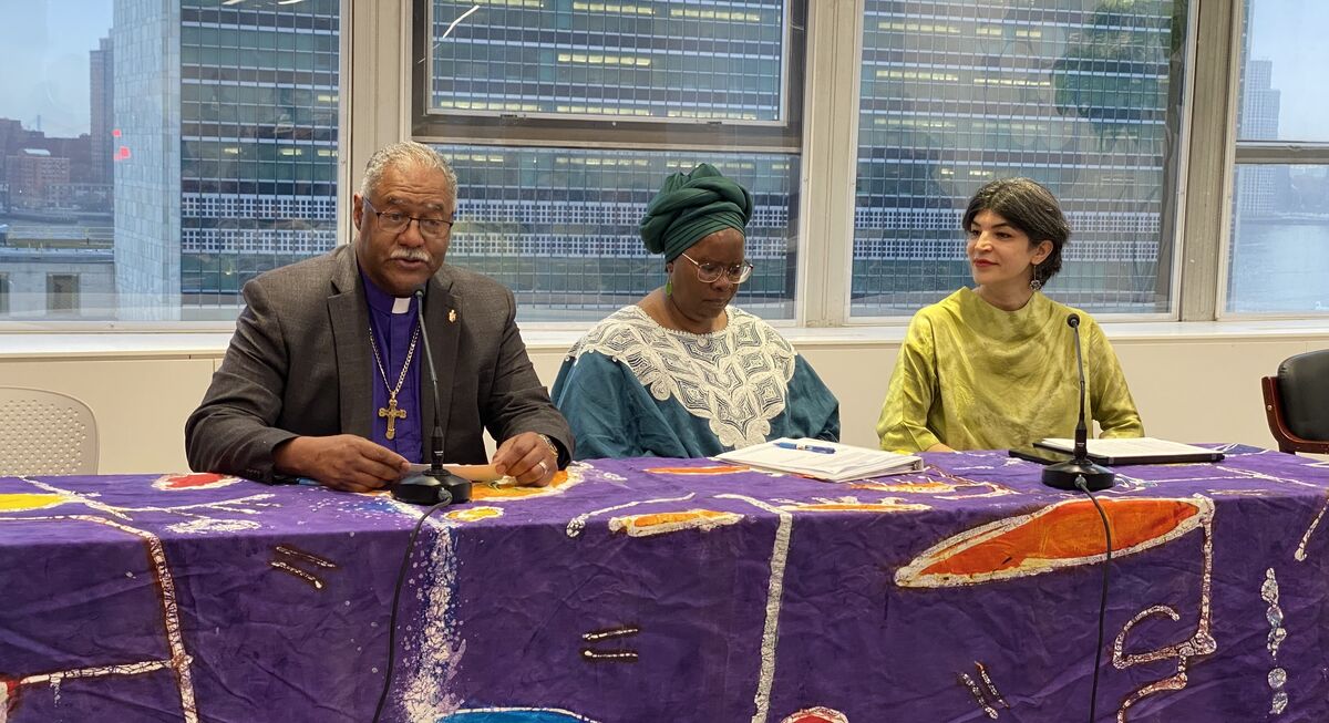 Bishop Trimble speaking with two other panelists