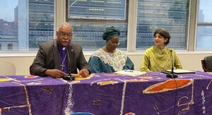 Bishop Trimble speaking with two other panelists