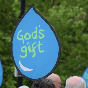 A sign in the shape of a water drop that reads "God's gift." 