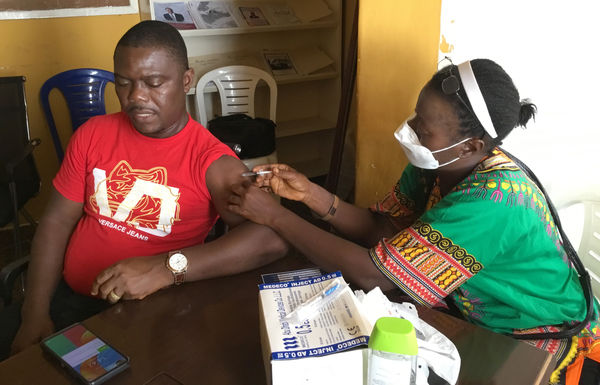A patient receives a COVID-19 vaccine at S. T. Nagbe United Methodist Church in Monrovia, Liberia. Photo by E Julu Swen, UM News.