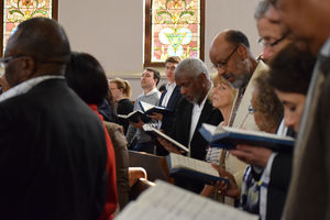 People sing hymns from books