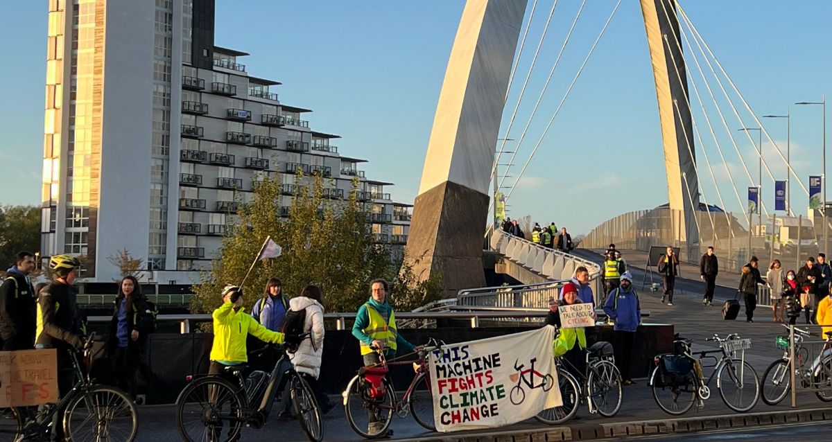 Cyclists outside the COP26 venue in Glasgow promote the importance of bicycle power.