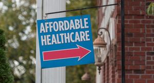 A sign that says "affordable healthcare" in front of a building.
