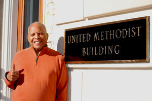 Mark Harrison gives a thumbs-up outside the United Methodist Building on Capitol Hill. Harrison, who has worked for the General Board of Church and Society there since 1991, retired on Nov. 30. Photo by Amber Gaines.