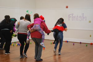 Children and adults play a game. 